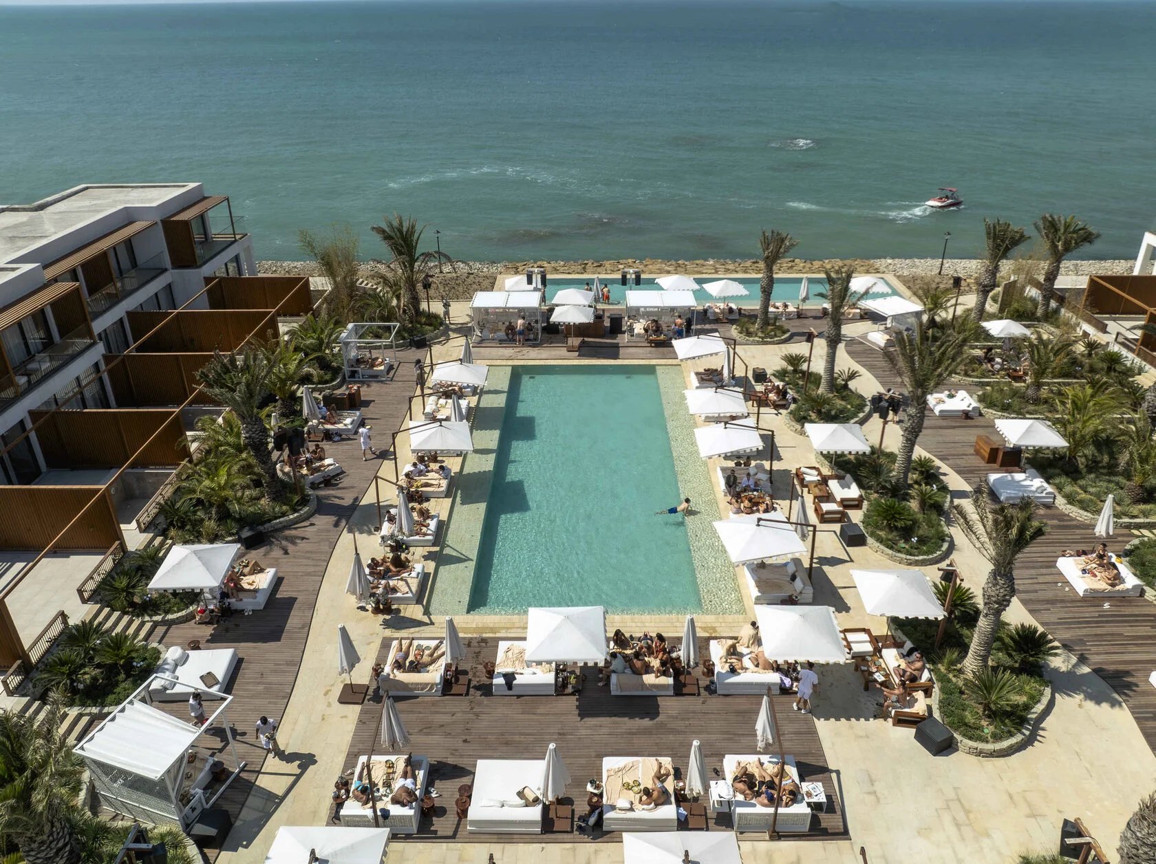 Beachfront pool with sun loungers at Sea Breeze Baku on the Caspian